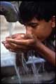 Boy drinking from tap