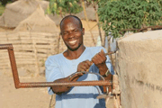 Man at a well in Nigeria: WaterAid/ Suzanne Porter