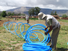 A man laying pipes in a field