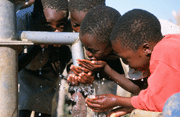 Boys drinking from tap