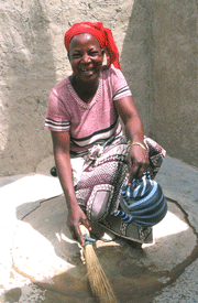 Woman Sweeping Latrine